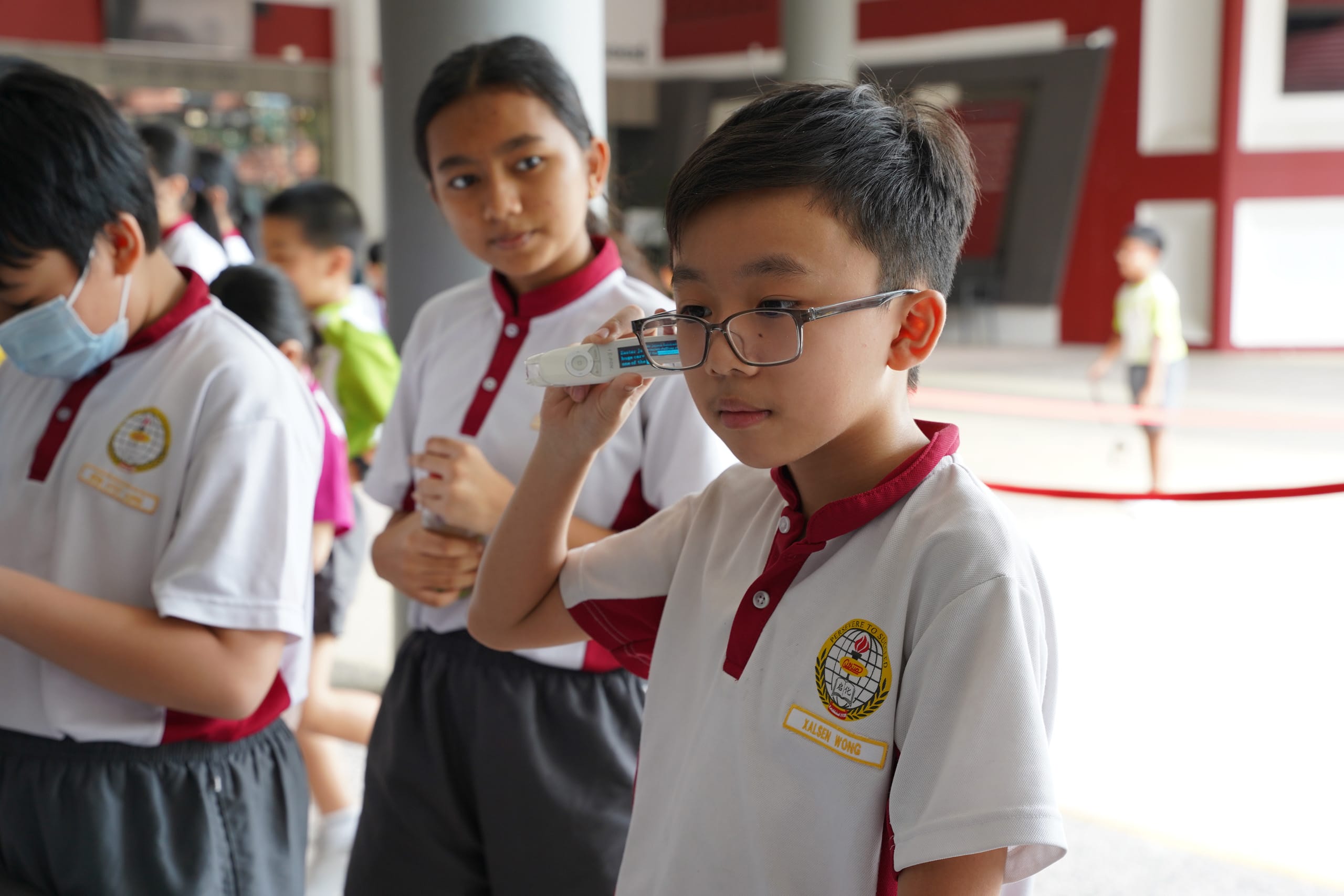 Student listening to a hearing aid device